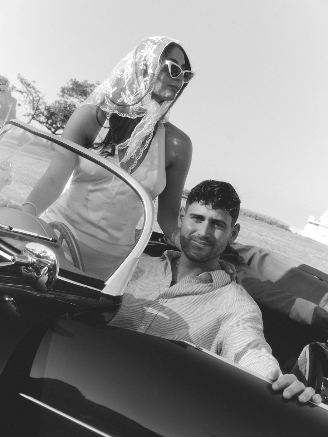 The couple in a vintage convertible, black and white